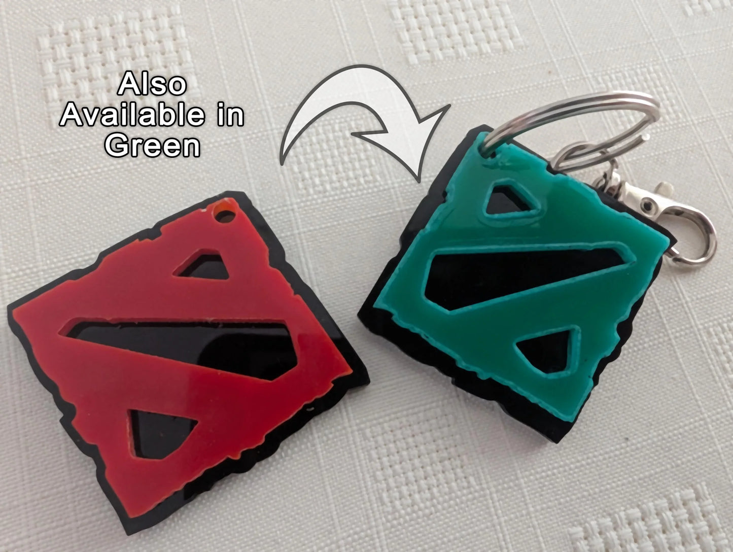 Custom acrylic keychains in red and green with geometric cutout designs on white background