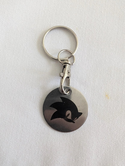Custom metal keychain with engraved black abstract animal design on white background