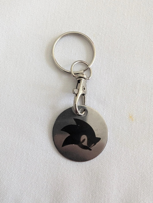 Custom metal keychain with engraved black abstract animal design on white background