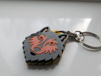 Custom acrylic wolf head keychain with layered grey and orange design on metal ring