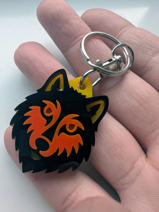 Acrylic wolf head keychain with black and orange design, custom handmade accessory
