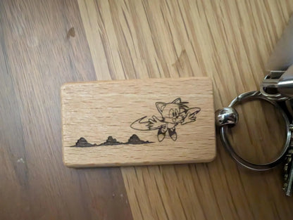 Engraved wood rectangular keychain with cartoon fox and mountains design on a keyring