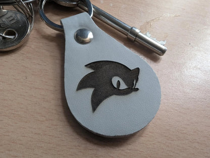 Custom engraved leather keychain with stylized hedgehog face on a keyring