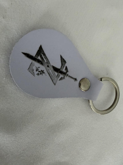 Custom engraved metal keychain with black geometric and sword design on white background