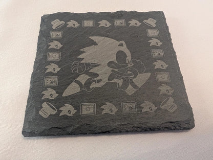 Engraved slate coaster featuring a running cartoon hedgehog and gaming icons, custom made