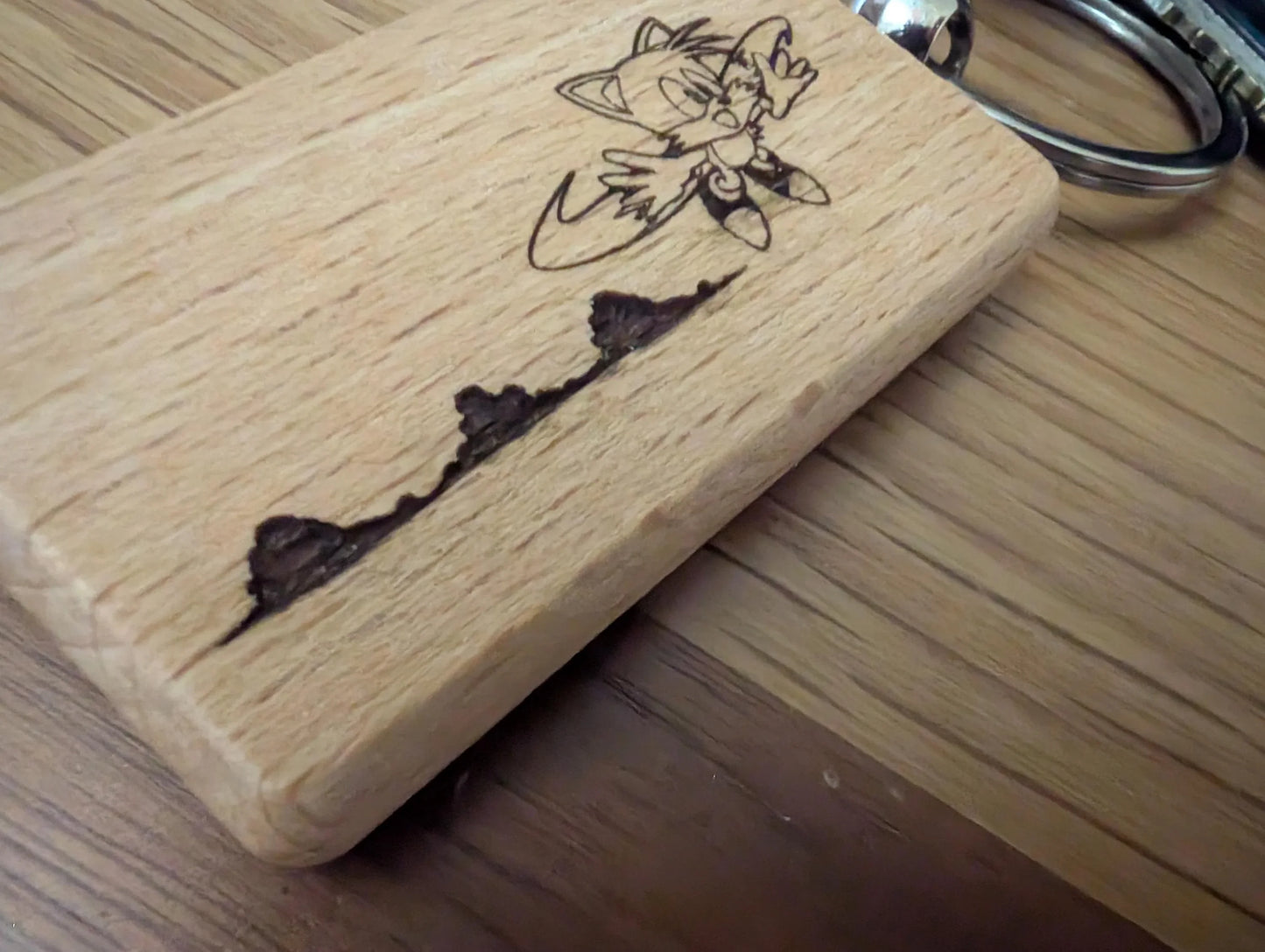 Custom engraved wooden keychain with cartoon character and natural wood grain detail