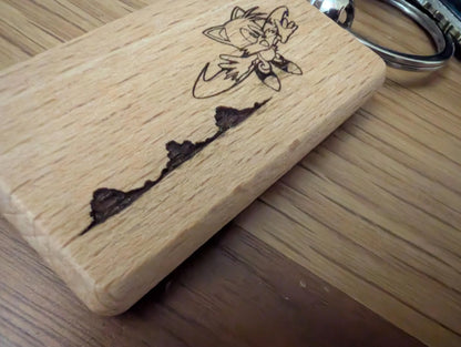Custom engraved wooden keychain with cartoon character and natural wood grain detail