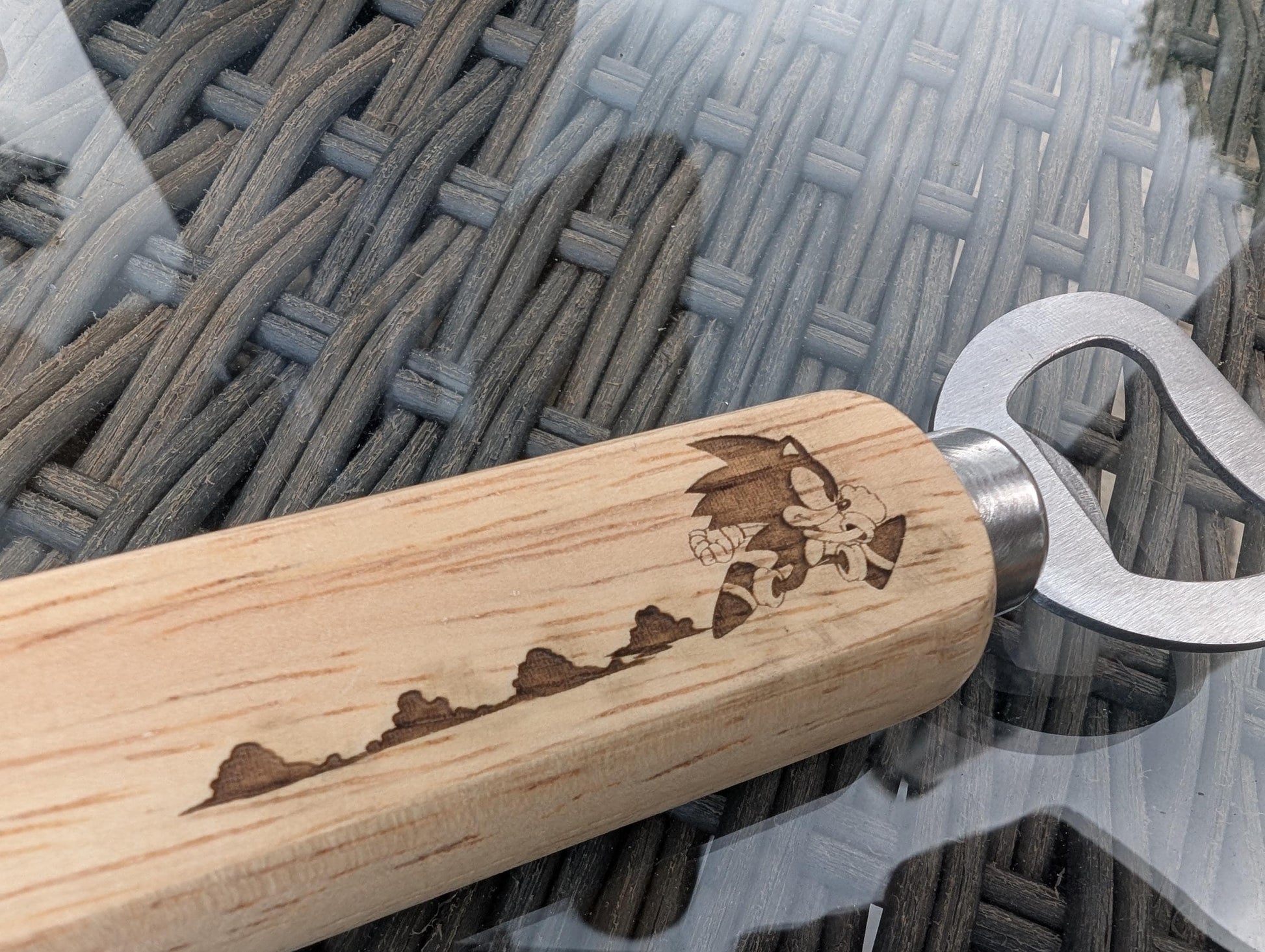 Wooden handle metal bottle opener with engraved cartoon character and running trail design