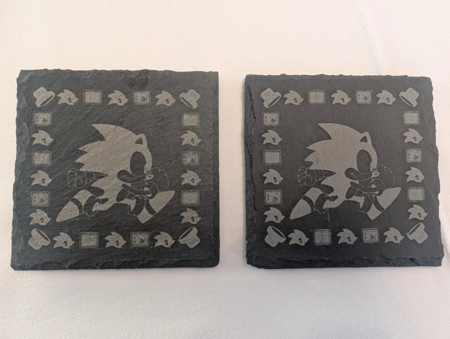 Set of two engraved slate coasters with running cartoon hedgehog design, custom made